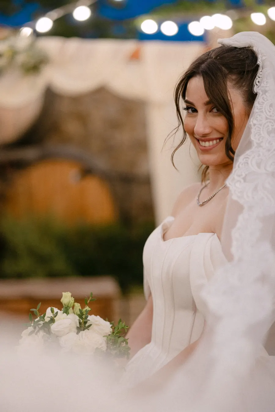 Bride in veil, string lights